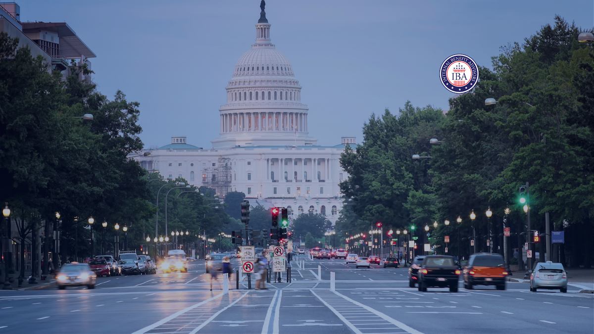 The Capitol dome at dusk at the end of a busy Washington avenue