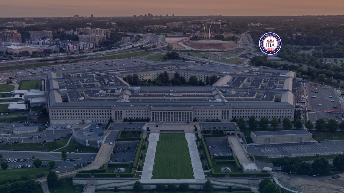 An aerial view of the Pentagon at dusk, with the city skyline behind it