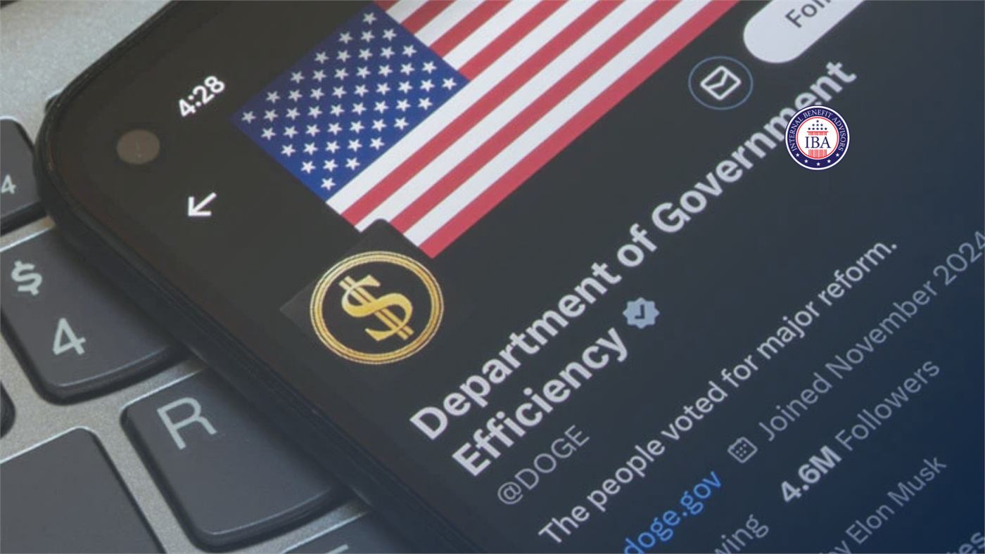 A phone showing the Department of Government Efficiency account on X, resting on a keyboard beside an American flag