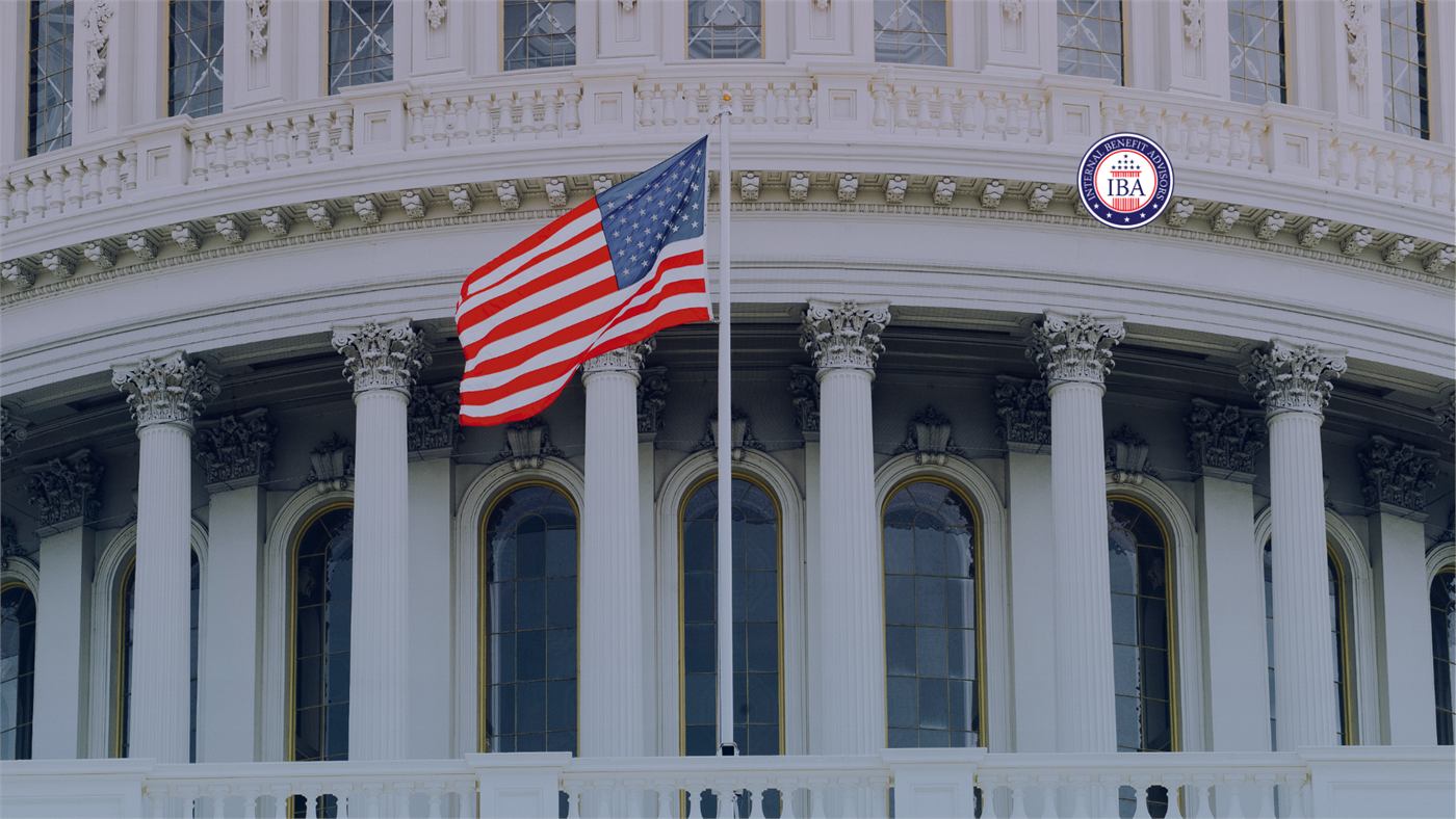 An American flag flying in front of the columns and dome of the Capitol