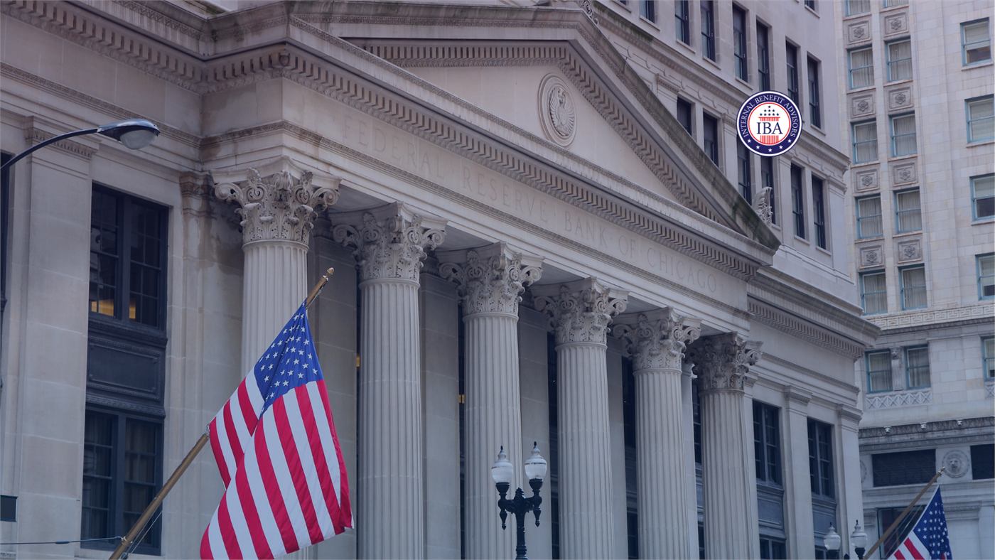 An American flag flying outside a classical building with tall stone columns