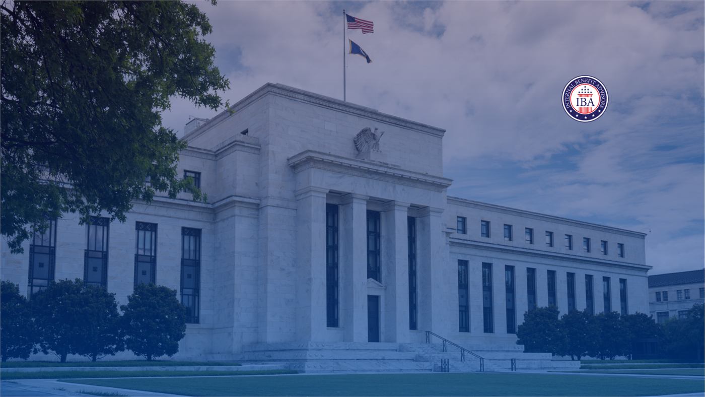 The Federal Reserve building on a bright day, a flag flying above the roofline