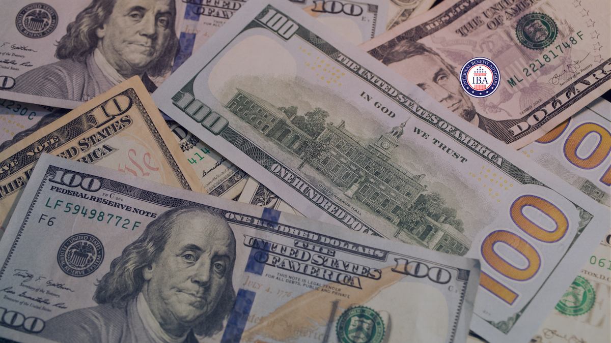 A loose pile of US one hundred dollar bills