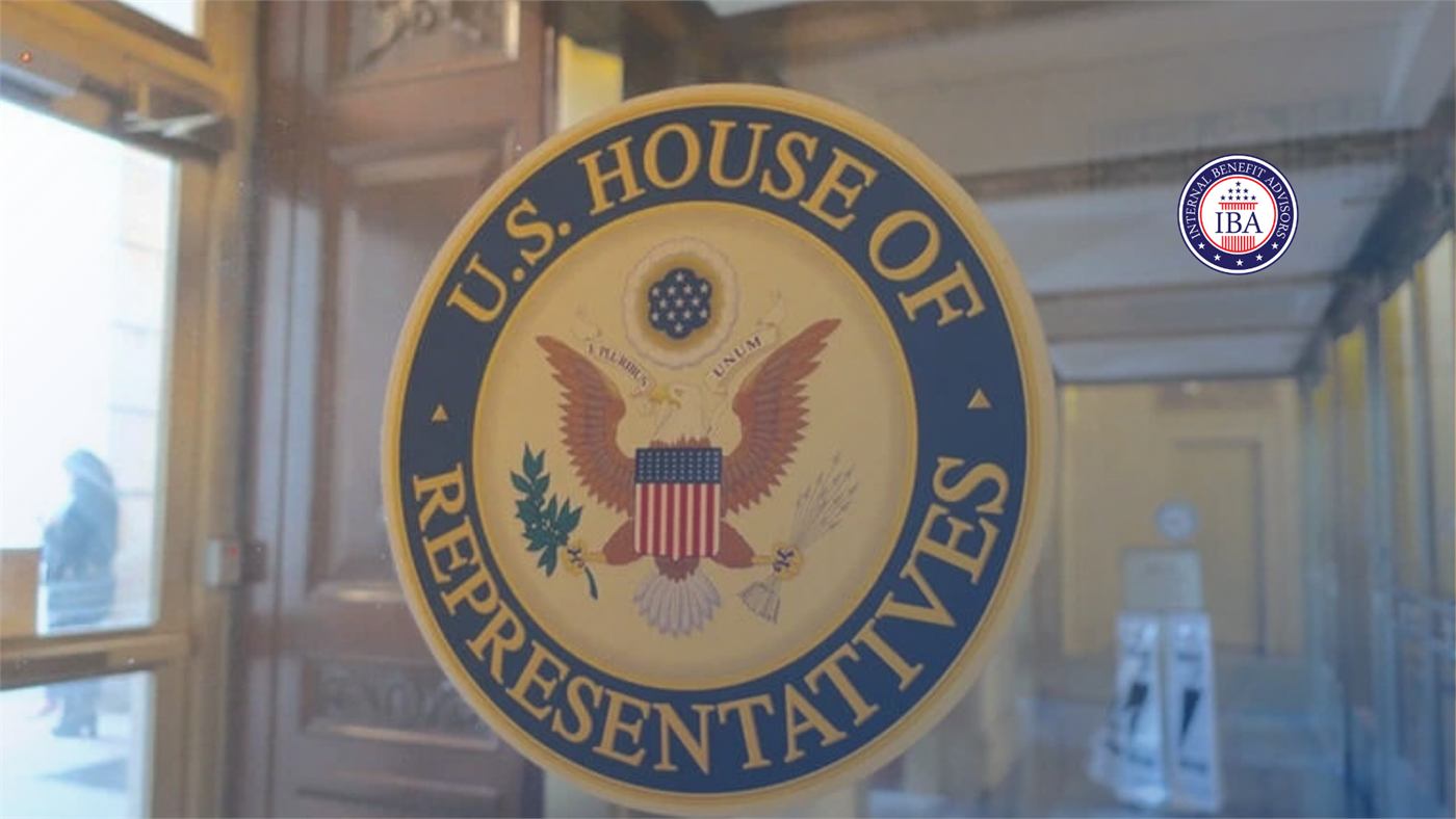 The seal of the U.S. House of Representatives on a glass door in a bright lobby