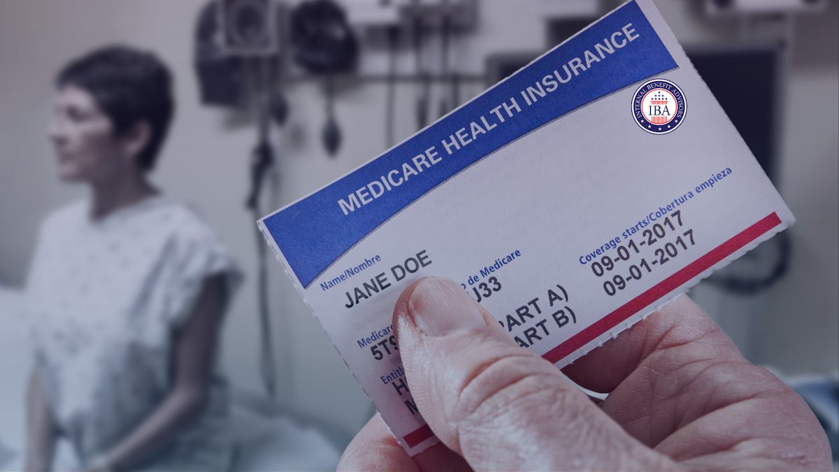 A hand holding a Medicare health insurance card, a woman out of focus behind