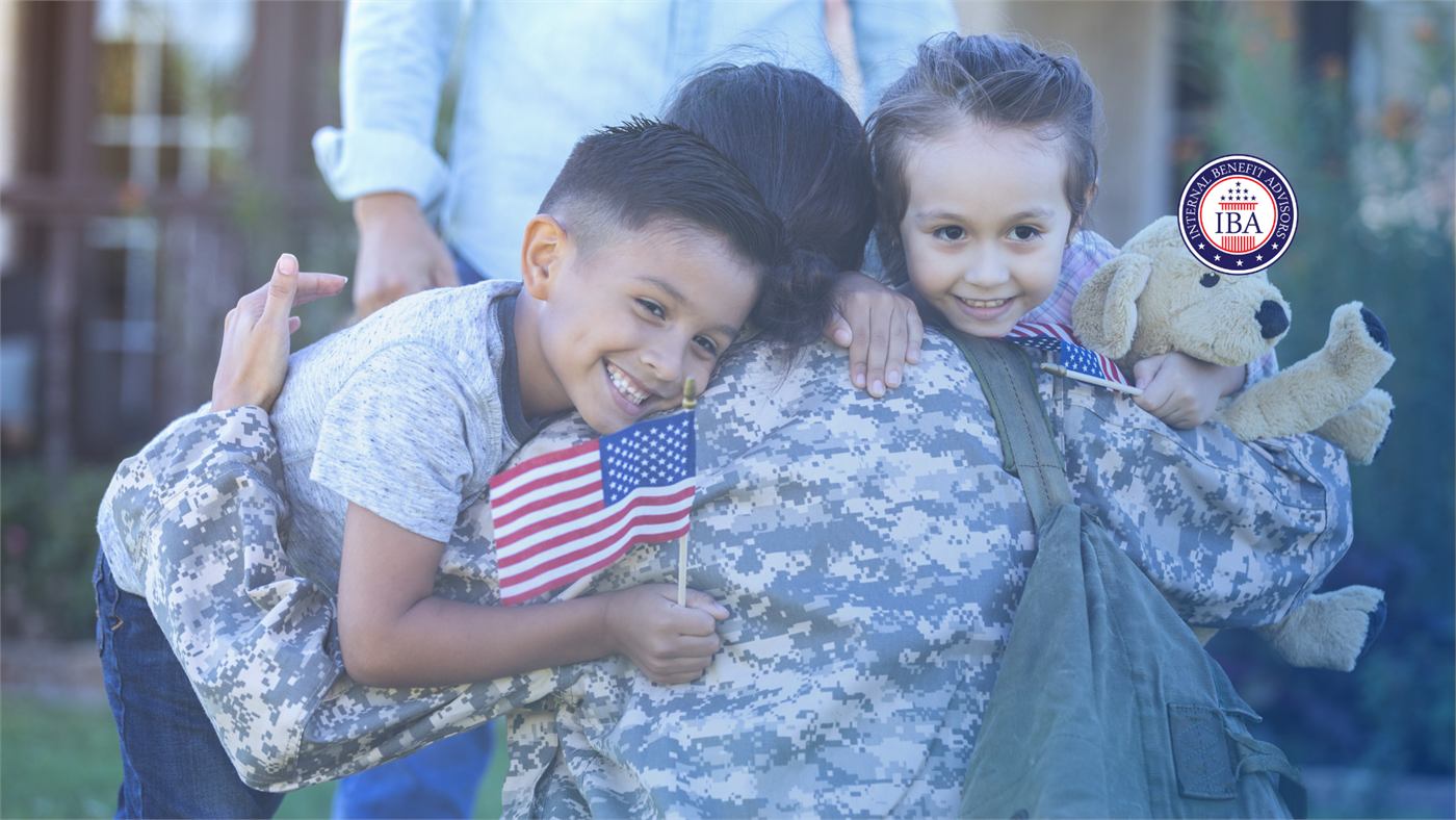 Children holding an American flag hugging a service member in camouflage uniform