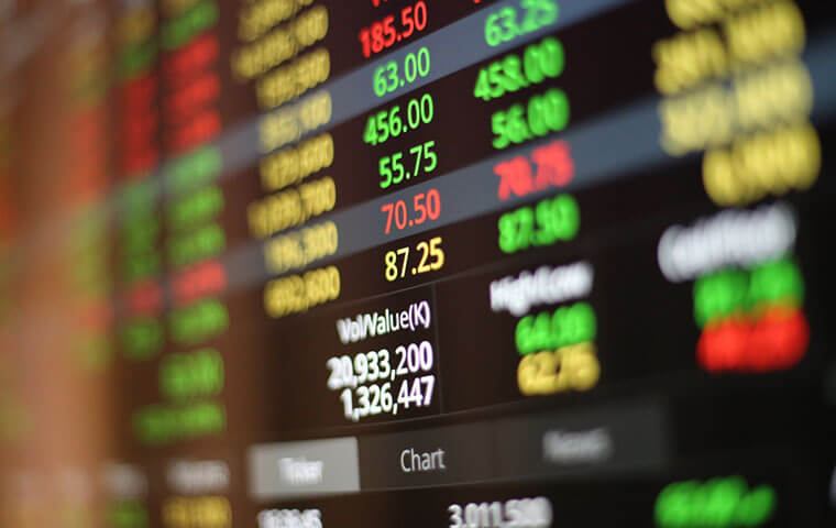 A stock market board showing green and red price quotes