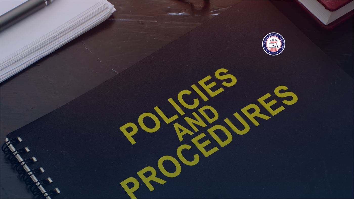 A notebook labelled Policies and Procedures on a desk