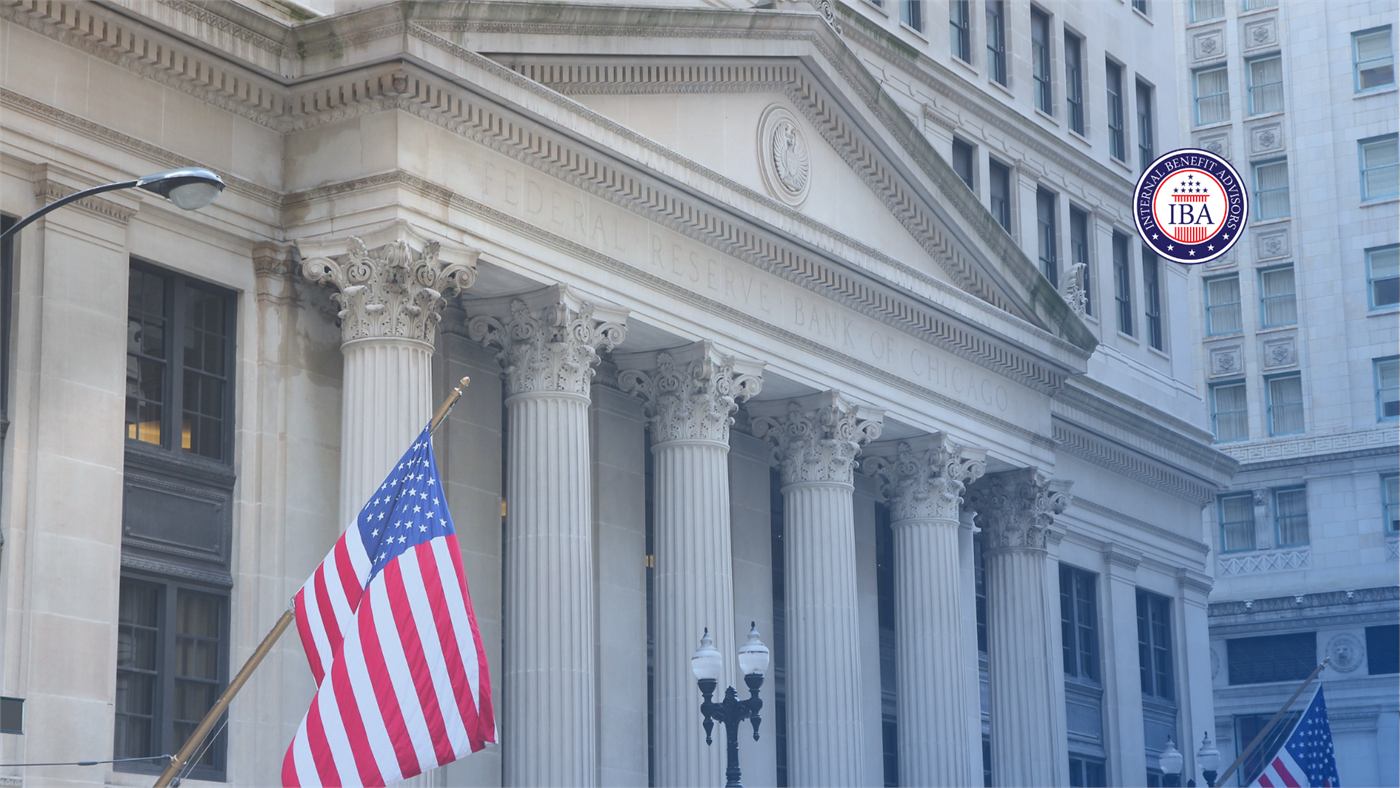 An American flag flying outside a classical stone government building