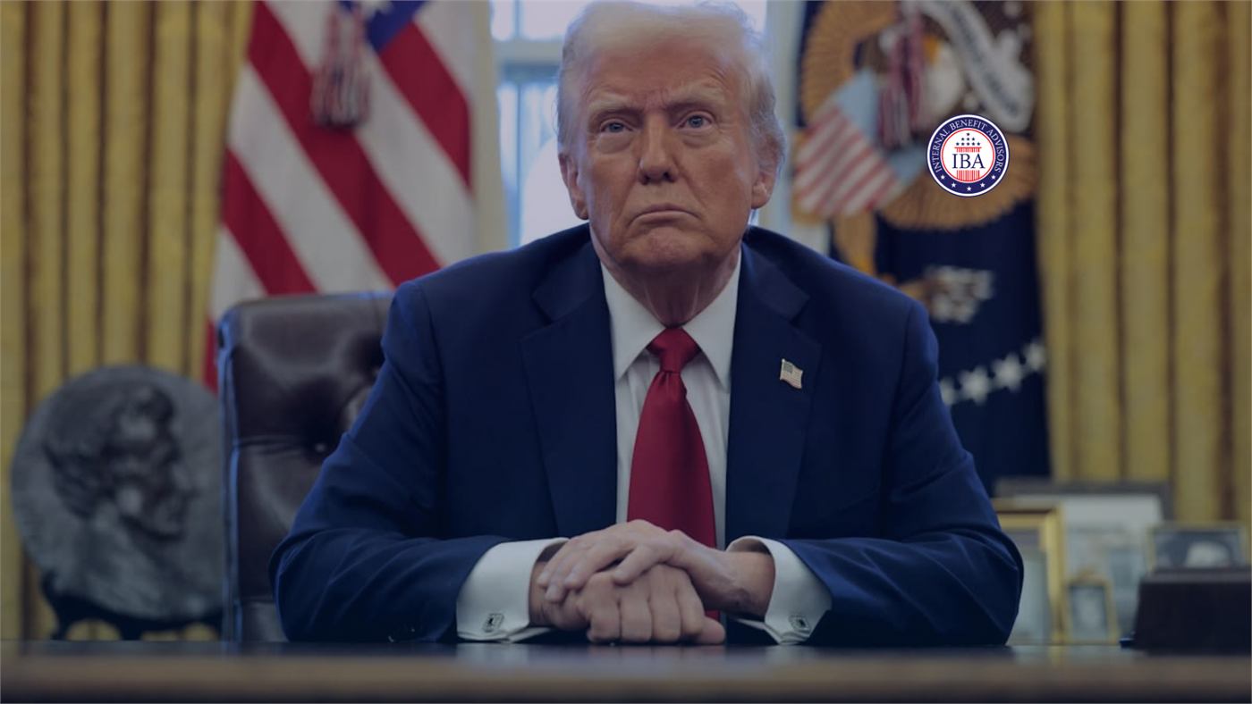 Donald Trump seated with his hands clasped in the Oval Office