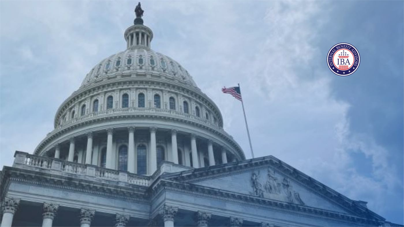 The Capitol dome and columned facade beneath a cloudy sky