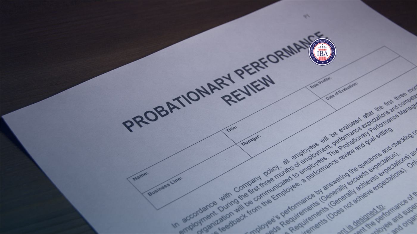 A blank Probationary Performance Review form on a desk