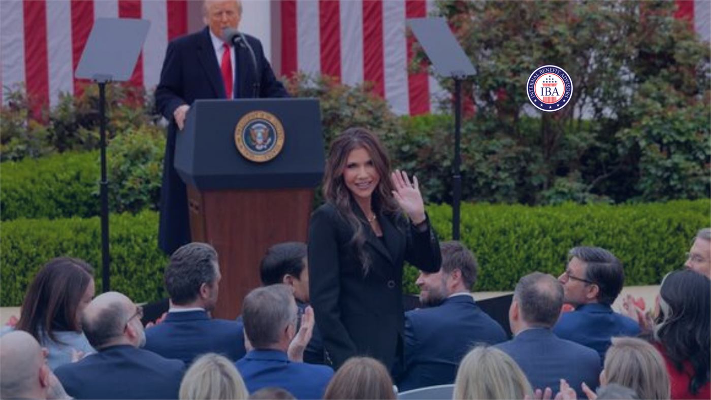 Donald Trump speaking at a podium with a woman beside him, addressing a seated outdoor audience