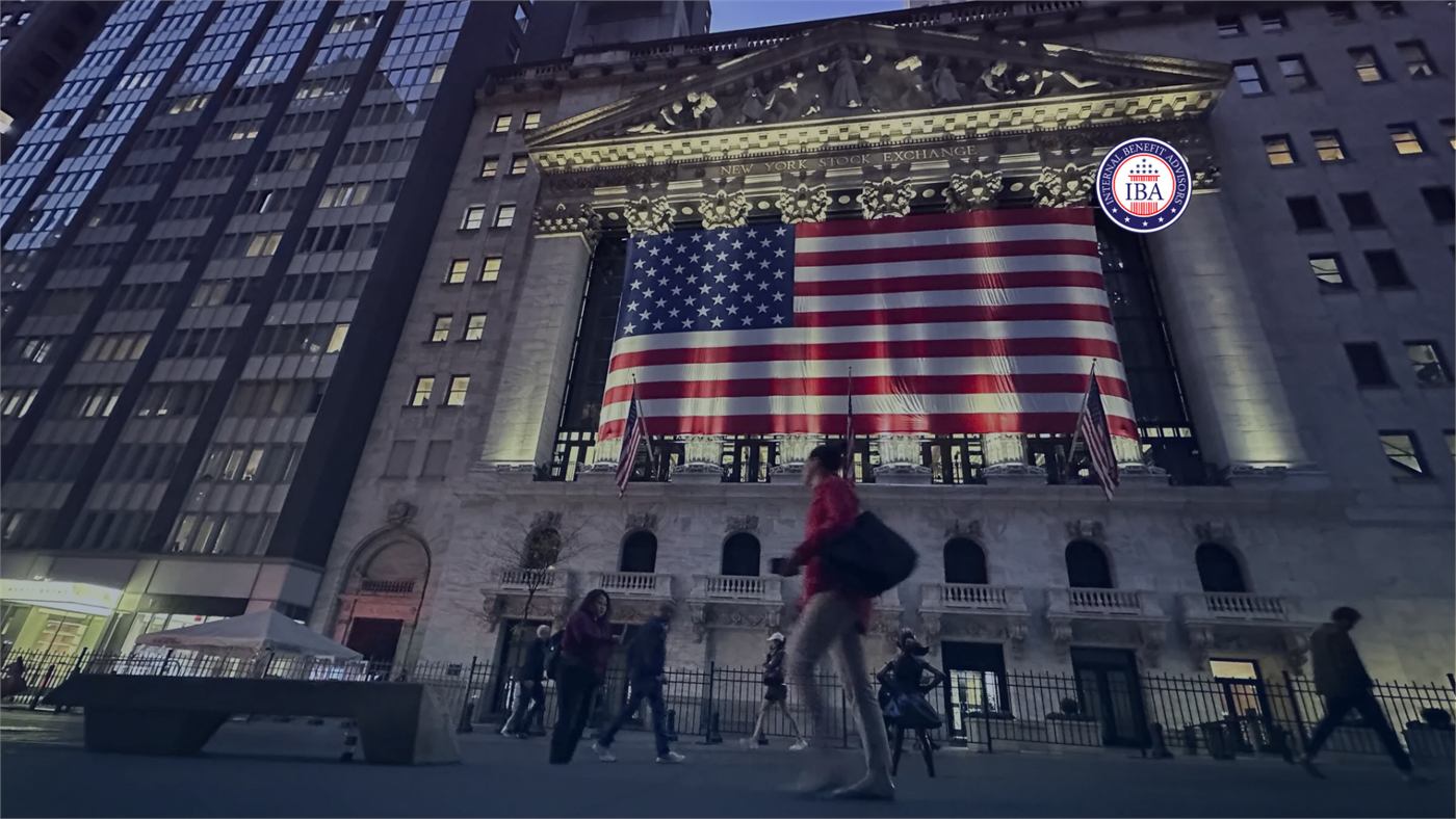 The New York Stock Exchange building draped with a large American flag