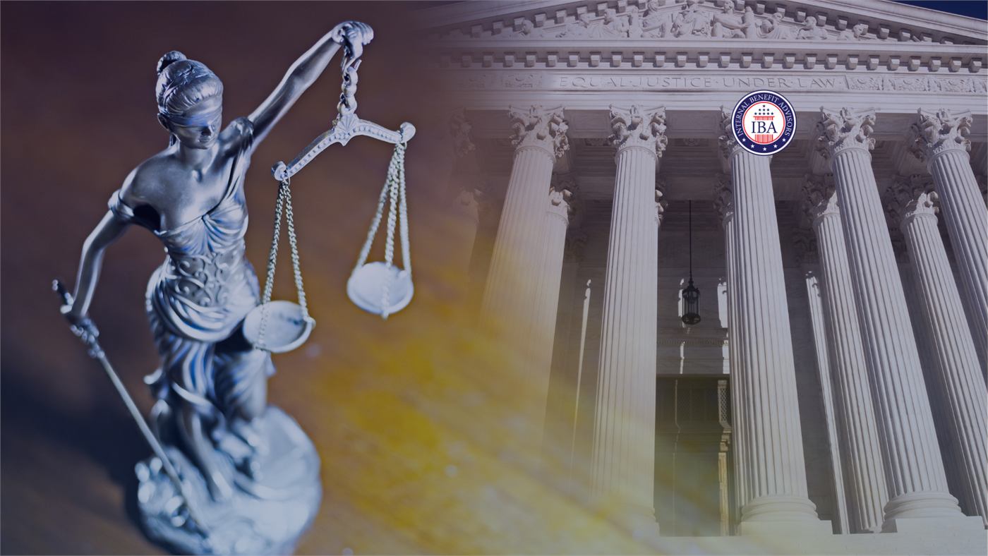 A statue of Lady Justice holding her scales in front of a columned courthouse