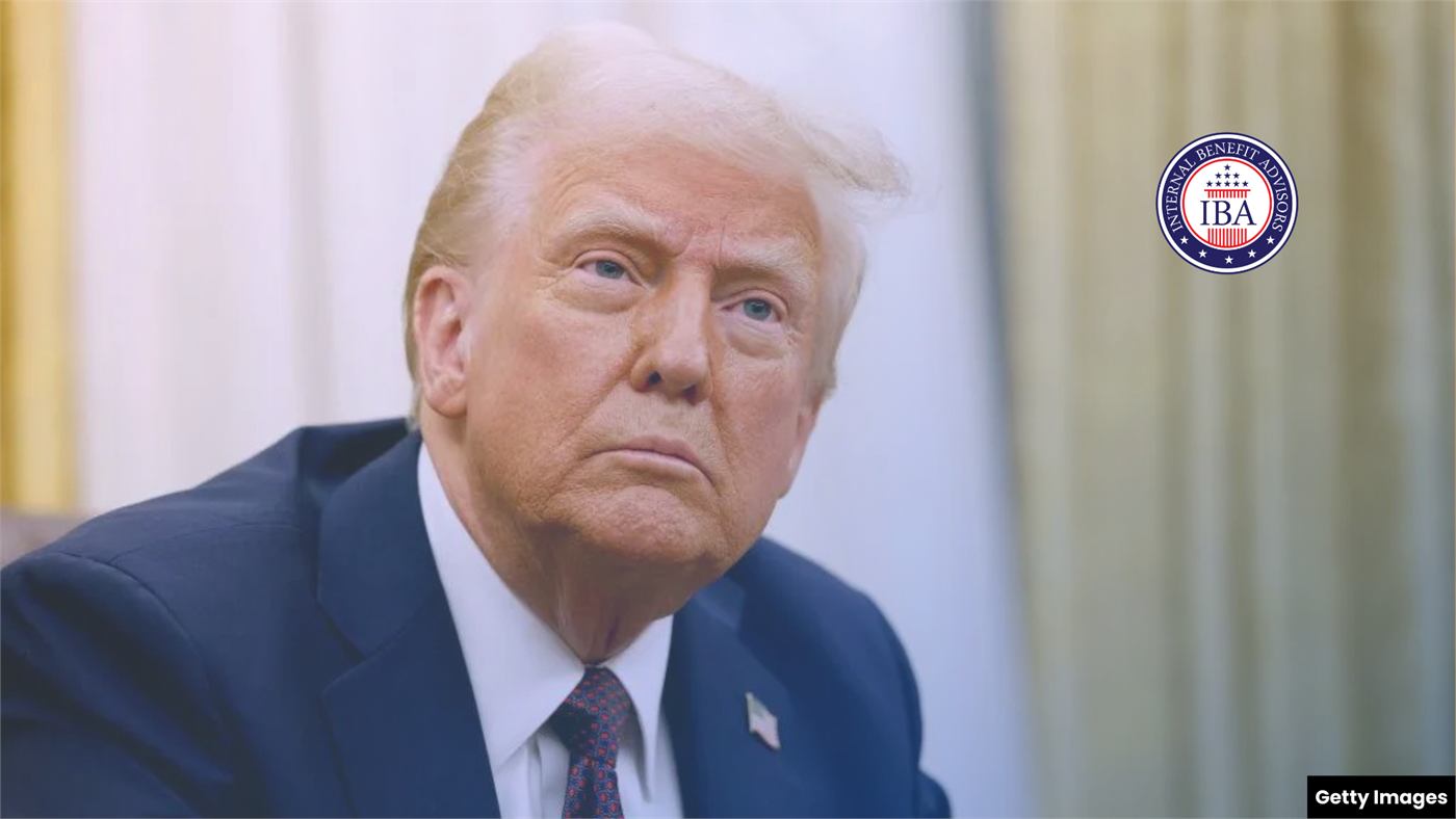 Donald Trump seated indoors, looking toward the camera