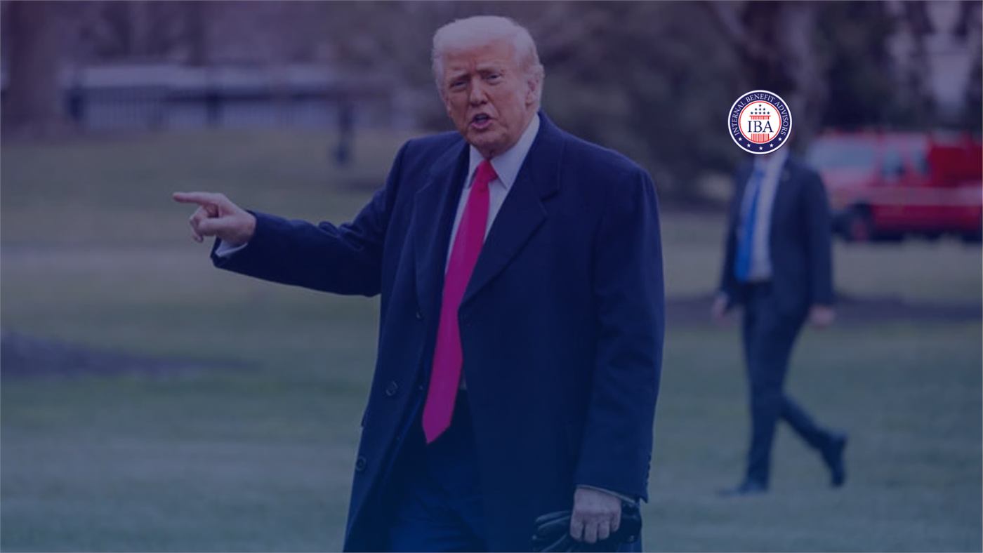 Donald Trump pointing as he walks across a lawn