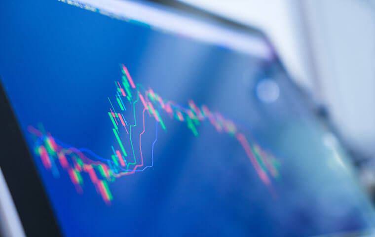 A close-up of a candlestick trading chart on a screen